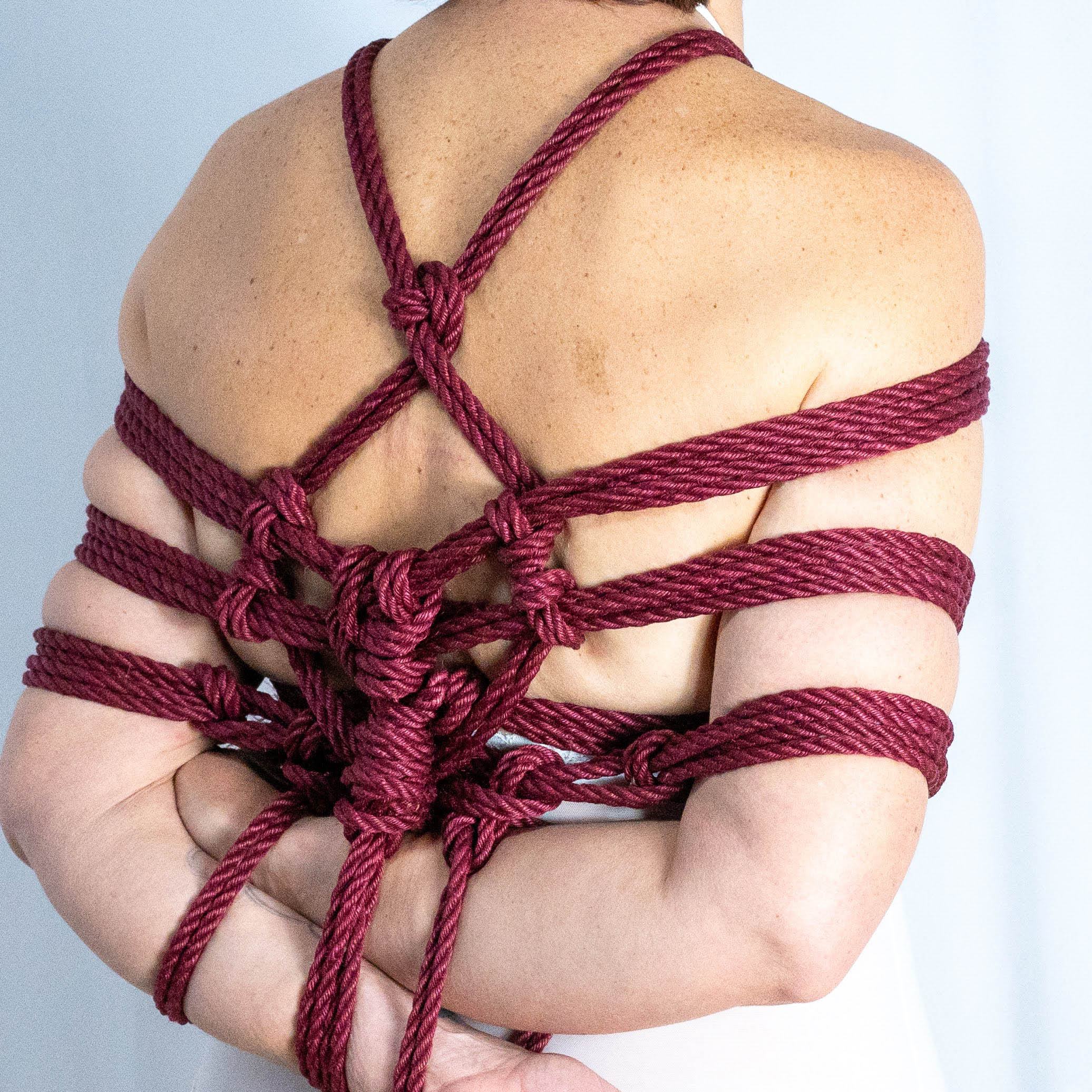 Shibari photography, Red Cherry jute shibari rope, on Cheshire of Reborn Ropes